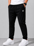 SWAGZAAR men's black lycra track pants with premium stretchable fabric, regular fit, zipper pockets and adjustable drawstring waist, ideal for gym, running, sports, workouts and everyday casual wear.